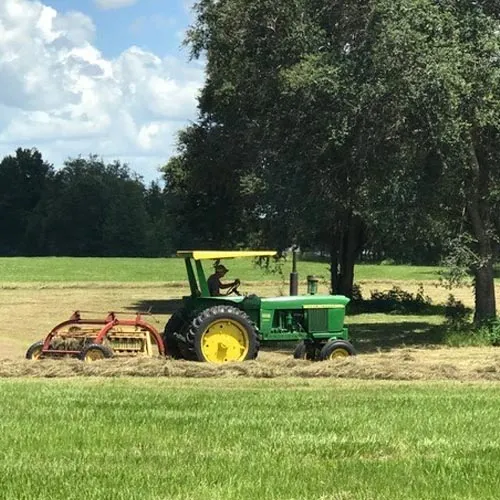 A tractor is parked in the middle of a field.